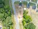 Aerial view of home surrounded by lush greenery and mature trees at 22 Van Winkle St, Lillington, NC 27546