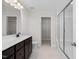 Double vanity bathroom with a large walk in shower, and linen closet at 22 Van Winkle St, Lillington, NC 27546