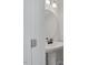 Small bathroom with pedestal sink and round mirror at 22 Van Winkle St, Lillington, NC 27546