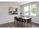 Well-lit dining room with hardwood floors, stylish table and chairs, and modern artwork at 22 Van Winkle St, Lillington, NC 27546