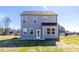 Two story house with gray siding and backyard at 22 Van Winkle St, Lillington, NC 27546