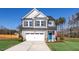 Two-story house with gray siding, white garage door, and blue front door at 22 Van Winkle St, Lillington, NC 27546
