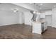 Open kitchen with island, white cabinets, and granite countertops at 22 Van Winkle St, Lillington, NC 27546