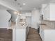 Modern kitchen with white cabinets, granite countertops, and island at 22 Van Winkle St, Lillington, NC 27546