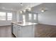 Open kitchen features a large island with granite countertops and stainless steel appliances at 22 Van Winkle St, Lillington, NC 27546