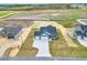 Aerial view of new construction featuring a three-car garage and large concrete driveway at 208 Hillwood Dr, Sanford, NC 27332