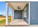 Relaxing covered back porch with white pillars, offering an ideal space for outdoor enjoyment at 208 Hillwood Dr, Sanford, NC 27332