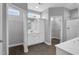 Beautiful bathroom featuring white cabinets, dual sinks, and walk-in closet access at 208 Hillwood Dr, Sanford, NC 27332
