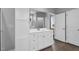 Bathroom featuring white cabinets, dual sinks, and a walk-in shower at 208 Hillwood Dr, Sanford, NC 27332
