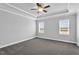 Spacious bedroom with tray ceiling, ceiling fan, two windows and neutral carpeting at 208 Hillwood Dr, Sanford, NC 27332