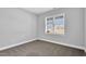 This carpeted bedroom has natural light and a neutral color scheme, creating a blank canvas at 208 Hillwood Dr, Sanford, NC 27332