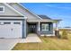 Charming home entrance with a welcoming porch, stylish columns, and a well-manicured lawn at 208 Hillwood Dr, Sanford, NC 27332
