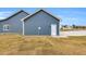 Blue vinyl siding with white trim creates a clean and modern exterior aesthetic at 208 Hillwood Dr, Sanford, NC 27332