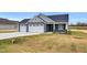 Picture-perfect single-story home featuring a spacious two-car garage, and well-manicured lawn at 208 Hillwood Dr, Sanford, NC 27332