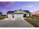 Beautiful single-Gathering home featuring a spacious driveway, two-car garage, and classic architectural details at 208 Hillwood Dr, Sanford, NC 27332