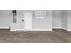 A well-lit garage features a door and built in wall organizer for efficient storage at 208 Hillwood Dr, Sanford, NC 27332