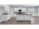Modern kitchen featuring granite countertops, white cabinetry, and a center island at 208 Hillwood Dr, Sanford, NC 27332