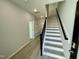 Bright entryway with staircase, built-in bench, and coat closet at 3014 Freewinds Way # 45, Cary, NC 27519