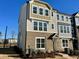 Three-story townhome with brick and siding exterior, showcasing a modern design at 3014 Freewinds Way # 45, Cary, NC 27519