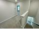 Upstairs hallway with carpet and access to bedrooms at 3014 Freewinds Way # 45, Cary, NC 27519