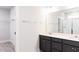 Bathroom features a double vanity, framed mirror, and tiled shower, creating a spa-like retreat at 556 Barbour Farm Ln, Four Oaks, NC 27524
