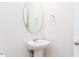 Small bathroom with pedestal sink, mirror, and towel ring at 556 Barbour Farm Ln, Four Oaks, NC 27524