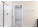 Enjoy this tiled shower with shelving that leads to a walk-in closet at 556 Barbour Farm Ln, Four Oaks, NC 27524