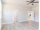 Spacious bedroom with wood-look flooring, ceiling fan, and neutral paint, perfect for relaxation at 556 Barbour Farm Ln, Four Oaks, NC 27524