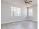 Bright bedroom featuring natural light, luxury vinyl floors and neutral decor at 556 Barbour Farm Ln, Four Oaks, NC 27524