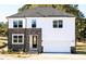 Inviting new construction home with stone and siding exterior, a garage, and manicured landscaping at 556 Barbour Farm Ln, Four Oaks, NC 27524