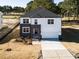 Beautiful new construction home with siding and stone exterior, a two-car garage, and landscaping near a golf course at 556 Barbour Farm Ln, Four Oaks, NC 27524