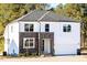 Charming new construction home featuring a stone and siding exterior with a two-car garage and clean landscaping at 556 Barbour Farm Ln, Four Oaks, NC 27524