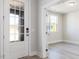 Welcoming foyer features a glass paneled front door, light gray walls, and light wood-look flooring at 556 Barbour Farm Ln, Four Oaks, NC 27524