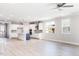 Bright, open-concept living space with hardwood floors and modern kitchen featuring a central island at 556 Barbour Farm Ln, Four Oaks, NC 27524