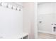 Functional mudroom with built-in bench, coat hooks, and adjacent laundry area at 556 Barbour Farm Ln, Four Oaks, NC 27524