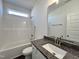 Bathroom featuring granite countertops, single sink, shower-tub and modern fixtures at 376 Longbow Dr, Middlesex, NC 27557