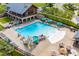 Fantastic aerial view of the community pool, including the area, lounge chairs, and clubhouse at 1142 Cottonsprings Dr, Wendell, NC 27591