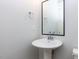 Bright bathroom featuring a pedestal sink, chrome fixtures, and a sleek, minimalist design at 1142 Cottonsprings Dr, Wendell, NC 27591