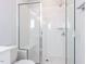 Modern white bathroom featuring glass-enclosed shower with bench and modern fixtures at 1142 Cottonsprings Dr, Wendell, NC 27591
