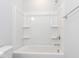 Bathroom featuring a sleek white shower and tub combination with built-in shelving at 1142 Cottonsprings Dr, Wendell, NC 27591
