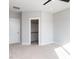 Well-lit bedroom featuring a ceiling fan, neutral carpet and an open closet at 1142 Cottonsprings Dr, Wendell, NC 27591