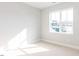 Bright, airy bedroom with plush carpet and a large window offering ample natural light at 1142 Cottonsprings Dr, Wendell, NC 27591