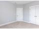 Cozy bedroom with neutral carpet, white trim, and ample closet space at 1142 Cottonsprings Dr, Wendell, NC 27591