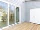 Modern outdoor wooden deck featuring sliding glass doors offering seamless indoor-outdoor living at 1142 Cottonsprings Dr, Wendell, NC 27591