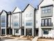 Charming townhome exterior with modern architectural details and fresh landscaping at 1142 Cottonsprings Dr, Wendell, NC 27591