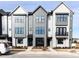 Modern townhome exterior with gray siding, large windows, and landscaped front yard at 1142 Cottonsprings Dr, Wendell, NC 27591