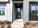 Inviting front entrance with a modern door and neatly landscaped surroundings at 1142 Cottonsprings Dr, Wendell, NC 27591
