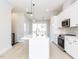 Bright, open kitchen with a large island, pendant lighting, and stainless steel appliances at 1142 Cottonsprings Dr, Wendell, NC 27591