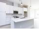 Modern kitchen with white cabinets, quartz countertops, and stainless steel appliances at 1142 Cottonsprings Dr, Wendell, NC 27591