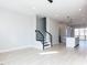 Open concept living room with hardwood floors seamlessly connects to the kitchen and staircase at 1142 Cottonsprings Dr, Wendell, NC 27591